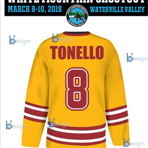 May include: A yellow hockey jersey with red and white stripes. The back of the jersey has the name "TONELLO" and the number "8" in red. The jersey also has the text "WEYMOUTH YOUTH HOCKEY" on the bottom. The jersey is for the White Mountain Shootout in Waterville Valley, NH.