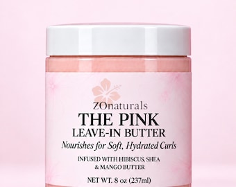 Könnte beinhalten: Ein zylindrischer Tiegel ZONaturals The Pink Leave-In Butter mit weißem Deckel und hellrosa Etikett mit Hibiskusblüten-Grafiken. Der Text lautet: THE PINK LEAVE-IN BUTTER, Nourishes for Soft, Hydrated Curls, INFUSED WITH HIBISCUS, SHEA & MANGO BUTTER, NET WT. 8 oz (237ml).