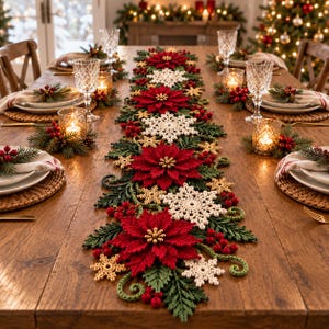 May include: A long, decorative Christmas table runner featuring crocheted red poinsettia flowers, white snowflakes, green pine sprigs, and small red berries. The runner is centered on a wooden table set with plates, napkins, and candles.