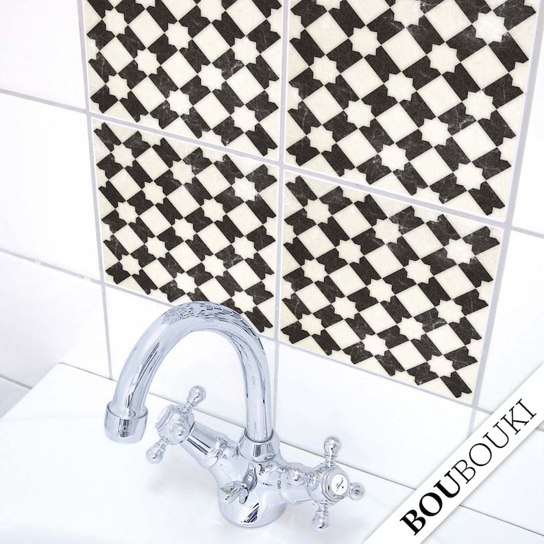 May include: Four black and white patterned tile stickers with a geometric design. The tiles are on a white tiled wall above a white porcelain sink with a chrome faucet.
