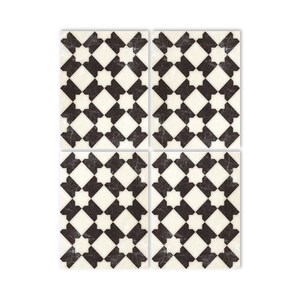 May include: Four black and white patterned square tiles with a geometric design. The tiles have a distressed, vintage look.