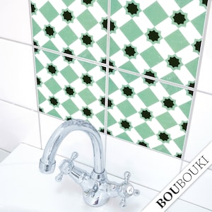 May include: Green and black patterned tile stickers for a bathroom or kitchen. The stickers are arranged in a grid pattern and feature a geometric design. The stickers are shown on a white tiled wall.