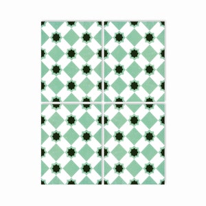May include: Four square ceramic tiles with a repeating pattern of black stars on a white and light green diamond background.