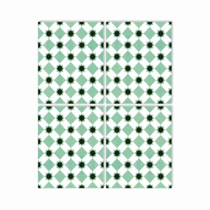 May include: Four square green and white ceramic tiles with a black starburst pattern.
