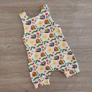 May include: White sleeveless romper with a colourful print of caterpillars, butterflies, apples and suns.
