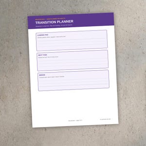 May include: A white paper planner sheet titled Transition Planner for Adults with a purple header. It features three sections labeled Landing Pad, Next Task, and Bridge, each with lined spaces for writing notes and tasks.