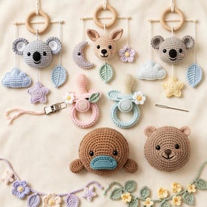May include: A collection of crochet items including three hanging mobiles with koala and deer heads, clouds, stars, and leaves. Two pacifier clips with floral accents, a brown platypus, a brown bear head, and two floral garlands with stars and leaves.