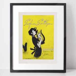 May include: A vintage advertisement for Parfum Sovleig by Le Galion Parfumeurs a Paris. The ad features a woman with long black hair playing a harp, with a yellow background and black and white illustration.