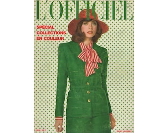 May include: A magazine cover featuring a woman wearing a green suit and a red hat. The magazine is titled "L'Officiel" and the text "Special Collections en Couleur" is printed on the cover.