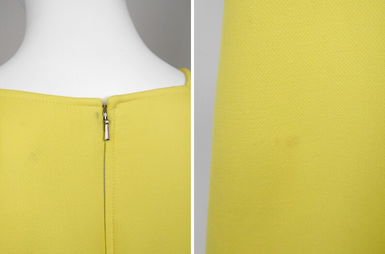 May include: Close-up of a bright yellow dress. The dress features a square neckline and a silver zipper closure at the back. The fabric has a subtle textured pattern. The dress is displayed on a white mannequin.