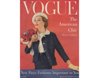 May include: Vogue magazine cover featuring a woman wearing a white hat and a navy blue suit holding a bouquet of red and purple flowers. The cover text reads "The American Chic" and "60 new fashions".