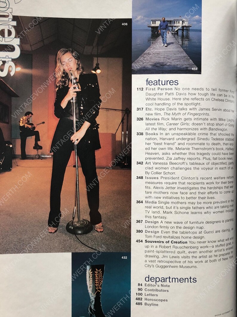 May include: A black and white photo of a woman singing into a microphone in a recording studio. The woman is wearing a black sequined top and black pants. The microphone is on a stand. The background is a white wall with a window. The photo is from a magazine article about the woman's career.