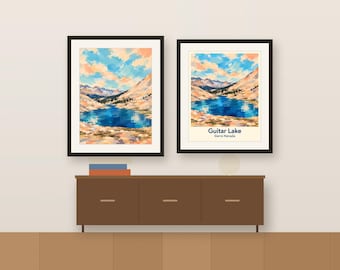 May include: Two framed wall art prints depicting a landscape of Guitar Lake in the Sierra Nevada mountains. The artwork features a deep blue lake surrounded by tan rocky peaks under a sky with blue and peach-coloured clouds and text.