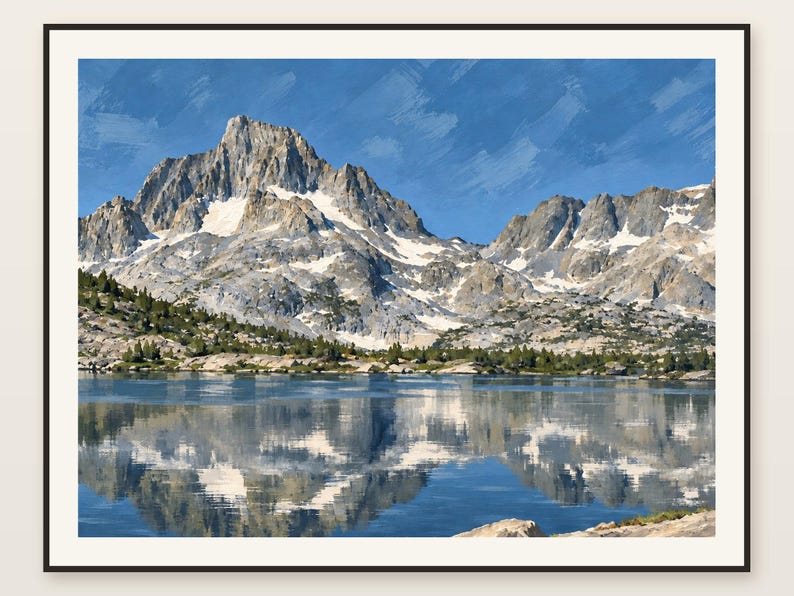 May include: A framed landscape print featuring a jagged, snow-capped mountain peak rising above a calm lake. The mountain is reflected in the water, with patches of green pine trees along the shoreline under a bright blue sky with brushstroke textures.