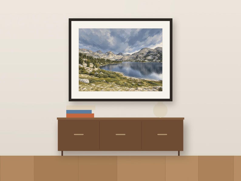 Rae Lakes gouache-style print in a dark frame above a wooden sideboard, shown as a room mockup