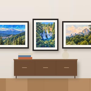 Three Northern California paintings framed in a row above a wooden sideboard, shown as a room mockup