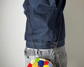 Upcycled crossbody clutch "Disturbed Nature" with hand-knitted I-cord rosettes