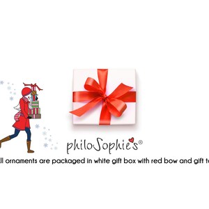 May include: A white gift box with a red bow and the text "philo Sophie's&reg;" on the front. The box is sitting on a white background. All ornaments are packaged in a white gift box with a red bow and gift tag.