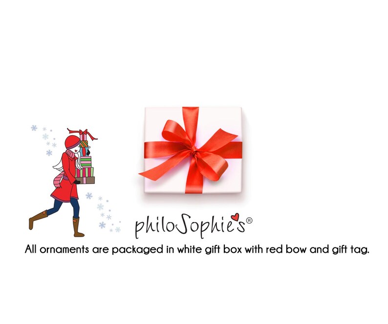 May include: A white gift box with a red bow and the text "philo Sophie's&reg;" on the front. The box is sitting on a white background. All ornaments are packaged in a white gift box with a red bow and gift tag.