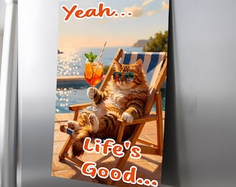 May include: A rectangular magnet featuring a fluffy brown tabby cat wearing sunglasses, lounging in a wooden deck chair by a pool, holding an orange cocktail with a straw. The text reads Yeah... Life's Good... in orange letters.