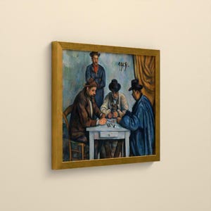 May include: A framed oil painting depicting four figures in a room. Three individuals sit around a white table, while one stands behind them. The figures wear hats and dark coats, with one person in a blue coat. The scene features muted blue and brown tones.