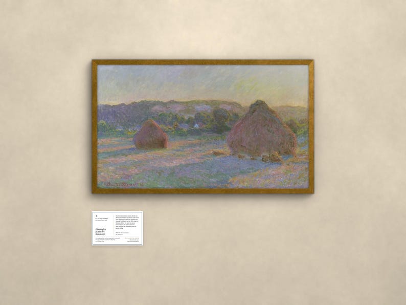 May include: A framed landscape painting depicting two large haystacks in a field at sunset, with soft purple and gold light casting long shadows across the grass. The artwork is signed Claude Monet 91 and includes a small informational placard.