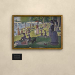 May include: A framed print of Georges Seurat's A Sunday Afternoon on the Island of La Grande Jatte, featuring a pointillist park scene with figures, trees, and a river. Below the frame is a small black plaque with white text detailing the artwork.