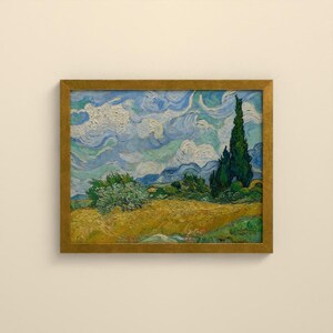 May include: A framed oil painting featuring a golden wheat field under a swirling blue and white sky. A tall, dark green cypress tree stands on the right side, while a smaller, rounded green bush is positioned in the center of the landscape.