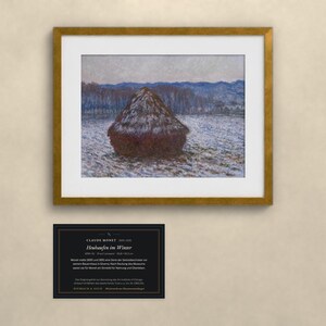 May include: A framed art print of Claude Monet's painting Heuhaufen im Winter, featuring a dark haystack in a snowy field with blue hills in the background. Below the frame is a black informational plaque with white text detailing the artwork.