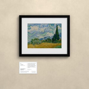 May include: A framed print of Vincent van Gogh's Wheat Field with Cypresses, featuring a golden wheat field, swirling blue sky, and dark green cypress trees. Below the artwork is a small white informational placard with black text.