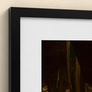 May include: A framed art print featuring a dark, moody painting with deep brown and gold tones, encased in a sleek black wooden frame with a wide white mat border that provides a clean contrast to the shadowed imagery within the frame.