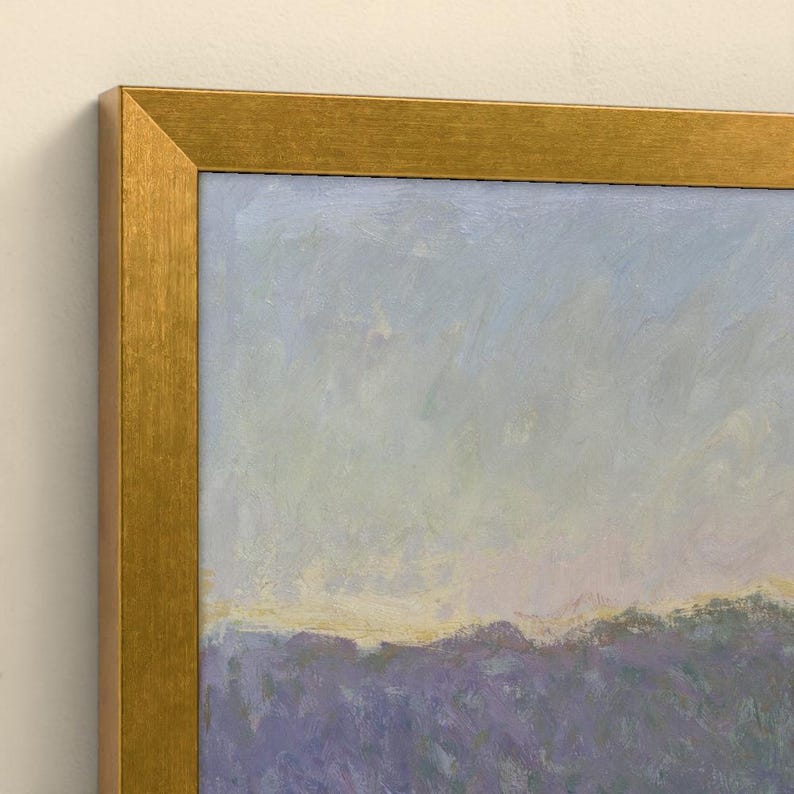 May include: A framed oil painting featuring a landscape with a field of purple flowers under a pale blue and yellow sky. The artwork is enclosed in a metallic gold frame with a textured finish, showcasing visible brushstrokes throughout the scene.