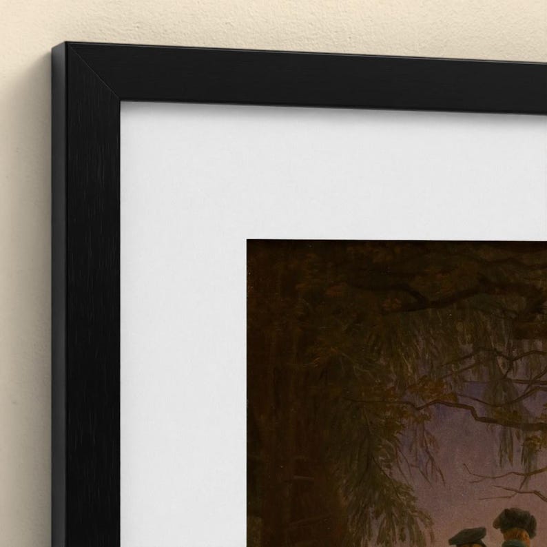 May include: A framed art print featuring a dark, moody landscape scene with silhouetted trees and figures under a twilight sky. The artwork is encased in a simple, thin black frame with a wide white mat border surrounding the central image.