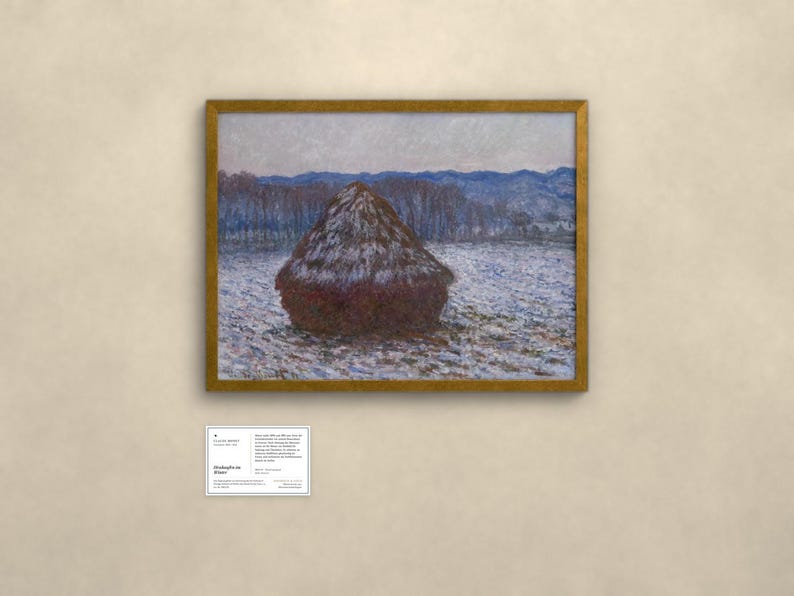 May include: A framed landscape painting featuring a large, dark brown haystack centered in a snowy field under a pale sky. In the background, blue-toned hills and trees are visible. Below the painting is a small white informational card with text.