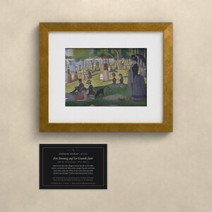 May include: A framed print of Georges Seurat's A Sunday on La Grande Jatte, featuring a park scene with figures, trees, and water. Below the gold-toned frame is a black informational card with white text detailing the artwork's history.