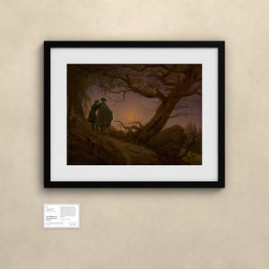 May include: A framed print of Caspar David Friedrich's painting Two Men Contemplating the Moon, featuring two figures standing on a rocky path beneath a gnarled tree, looking toward a crescent moon in a dark, twilight sky.