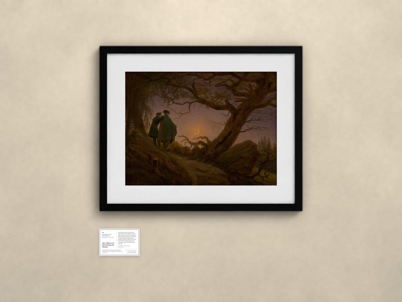 May include: A framed print of Caspar David Friedrich's painting Two Men Contemplating the Moon, featuring two figures standing on a rocky path beneath a gnarled tree, looking toward a crescent moon in a dark, twilight sky.