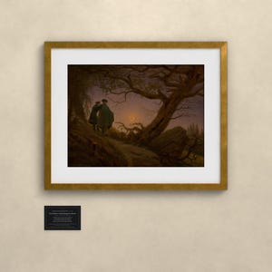 May include: A framed art print featuring a dark, moody landscape painting of two figures standing under a large, gnarled tree at twilight. The scene includes a crescent moon in the sky and a small black plaque below the frame with white text.