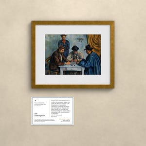 May include: A framed print of Paul C&eacute;zanne's painting The Card Players, depicting four figures at a table, with a white informational placard below featuring the text Paul C&eacute;zanne, Die Kartenspieler, and additional descriptive details.