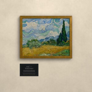 May include: A framed oil painting reproduction of Vincent van Gogh's Wheat Field with Cypresses, featuring a golden wheat field, a tall dark green cypress tree, and a swirling blue sky. Below the painting is a small black informational plaque.