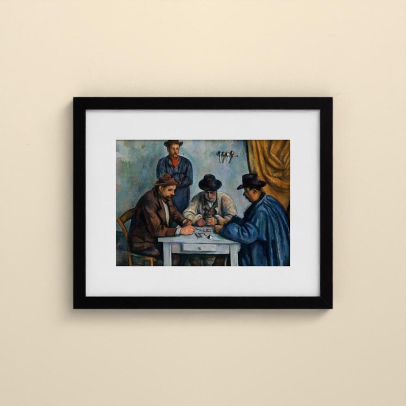 May include: A framed art print depicting a painting of four individuals gathered around a white table. Three people are seated wearing hats and dark coats, while one person stands behind them. The scene features muted blue and brown tones.