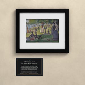 May include: A framed print of Georges Seurat's painting A Sunday on La Grande Jatte, featuring people in a park by the water. Below the frame is a black informational card with white text detailing the artwork, artist, and historical context.