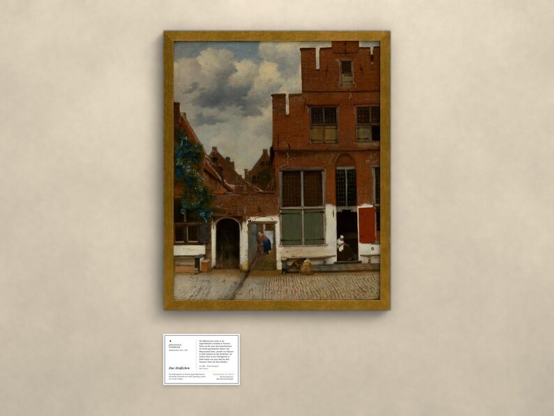 May include: A framed oil painting depicting a Dutch street scene with red brick buildings, a cobblestone path, and a cloudy sky. Below the painting is a small white informational plaque with black text detailing the artwork's history.
