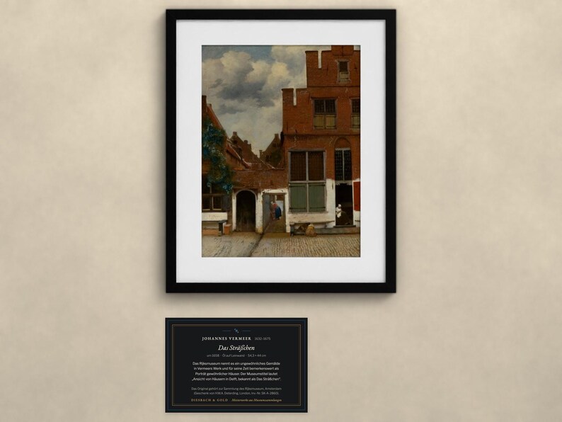 May include: A framed art print of Johannes Vermeer's painting The Little Street, depicting red brick houses and a cobblestone alleyway. Below the frame is a black informational plaque with white text detailing the artwork and artist.