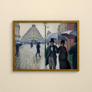May include: A framed oil painting depicting a rainy Paris street scene with cobblestones and tall buildings. Several figures walk with dark umbrellas, including a central pair in formal attire, a man in a top hat and coat, and a woman in a dark dress.