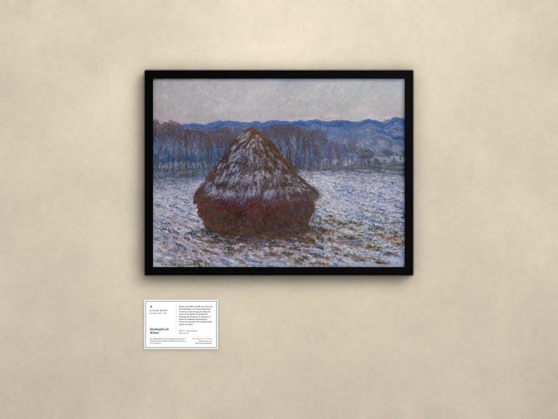 May include: A framed landscape painting featuring a large, dark brown haystack centered in a snow-covered field. In the background, a line of bare trees sits before blue, rolling hills under a pale sky. A small white informational plaque is below.