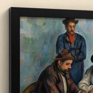 May include: A framed oil painting print depicting two men in hats. The man in the foreground wears a brown hat and jacket, while the man behind him wears a dark blue coat and a dark hat, with a pipe held between his lips, set against a blue background.