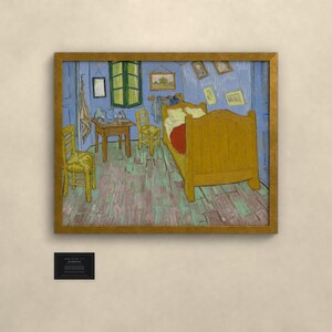May include: A framed print of Vincent van Gogh's Bedroom in Arles, featuring a yellow bed, two wooden chairs, a small table, and blue walls. The painting depicts a bedroom interior with various framed pictures on the wall and a green window.