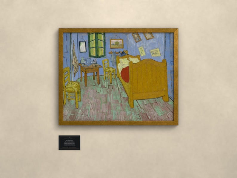 May include: A framed print of Vincent van Gogh's Bedroom in Arles, featuring a yellow bed, two wooden chairs, a small table, and blue walls. The painting depicts a bedroom interior with various framed pictures on the wall and a green window.