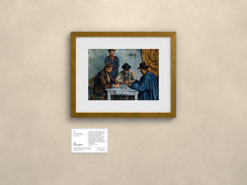 May include: A framed art print of Paul C&eacute;zanne's The Card Players, featuring four figures seated around a table playing cards. The painting is housed in a gold-toned frame and accompanied by a small informational card with text.